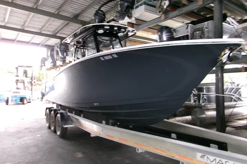  Yacht Photos Pics 2023 Sportsman Open 282 Center Console boat on trailer in storage facility.