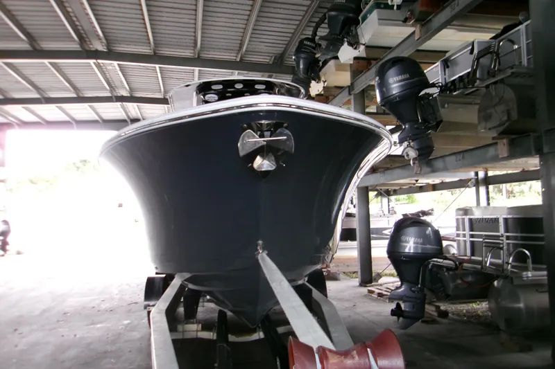  Yacht Photos Pics 2023 Sportsman Open 282 Center Console boat in storage, front view.