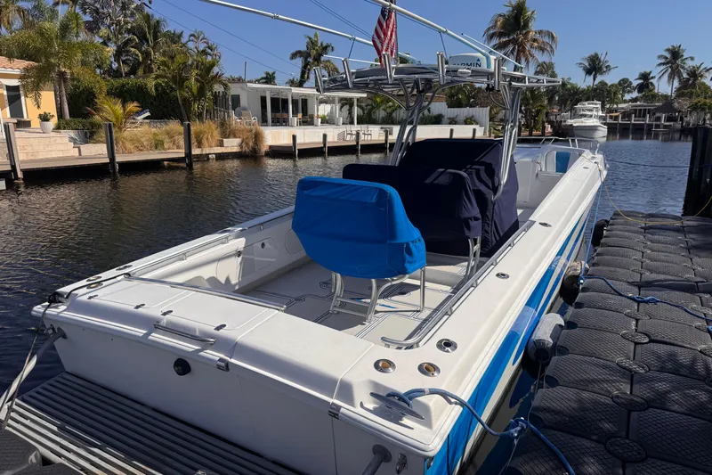  Yacht Photos Pics 2004 Don Smith 45 Custom boat docked by a scenic waterfront with palm trees.