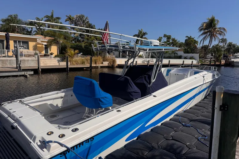  Yacht Photos Pics 2004 Don Smith 45 Custom boat docked by a canal, surrounded by palm trees.