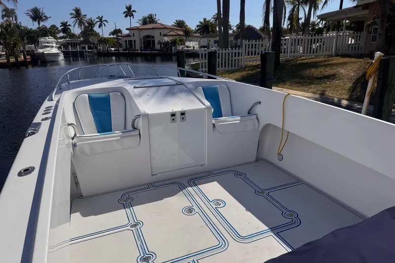  Yacht Photos Pics 2004 Don Smith 45 Custom boat interior with blue and white seating, docked by palm trees.