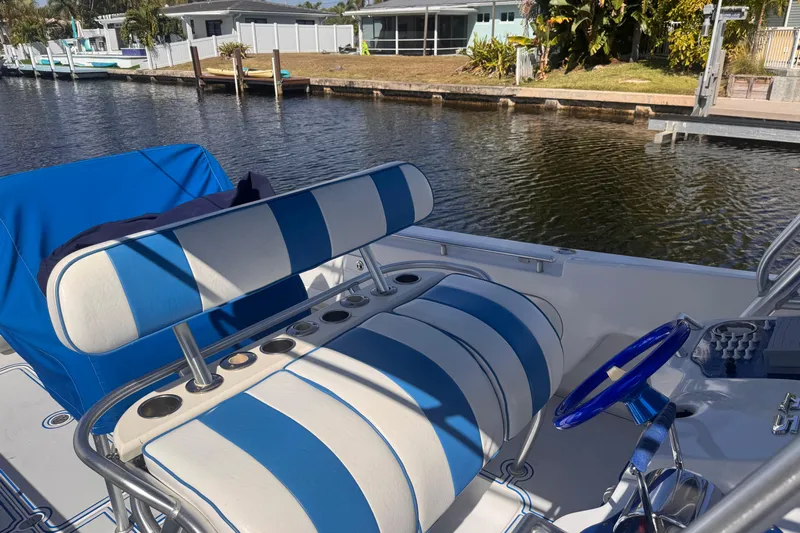  Yacht Photos Pics Blue and white striped seating on a 2004 Don Smith 45 Custom boat by a canal.
