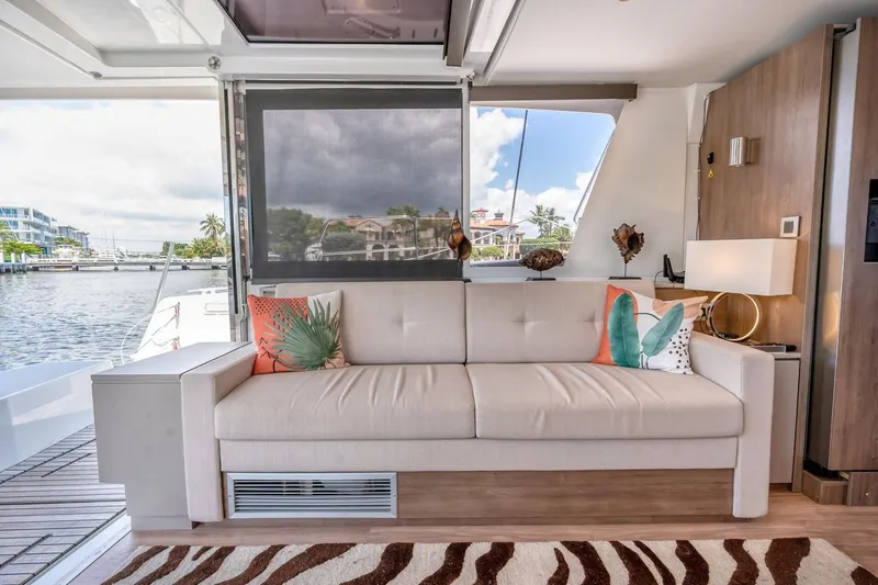 Dreamboat Annie Yacht Photos Pics Luxurious interior of 2022 Bali 4.8 yacht with elegant sofa and scenic water view.