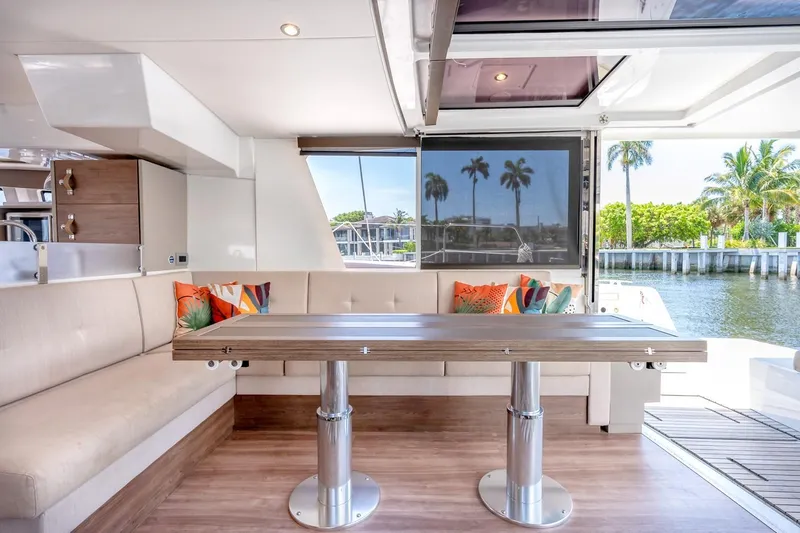 Dreamboat Annie Yacht Photos Pics Luxurious interior of 2022 Bali 4.8 yacht with modern seating and waterfront view.