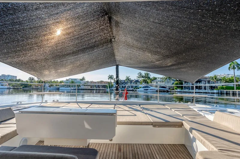 Dreamboat Annie Yacht Photos Pics Spacious deck of 2022 Bali 4.8 yacht with sunshade, overlooking serene waterfront and luxury homes.
