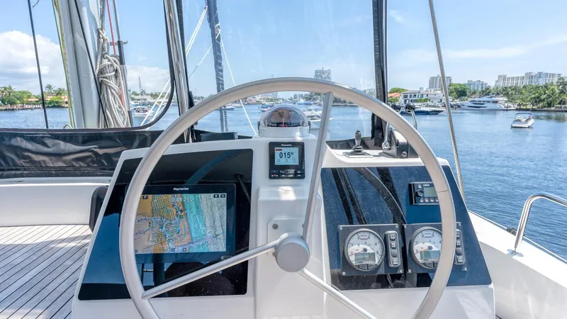 Dreamboat Annie Yacht Photos Pics Helm of 2022 Bali 4.8 catamaran with navigation equipment, docked in a marina.