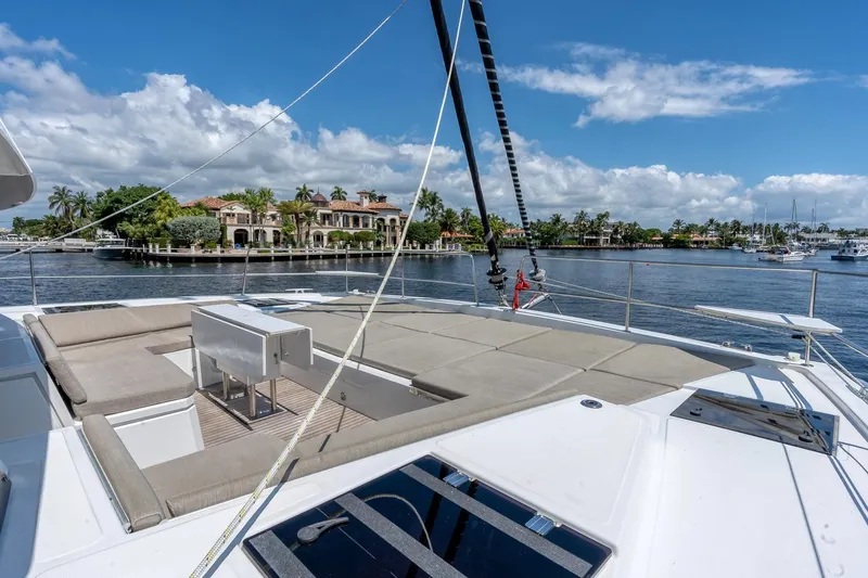 Dreamboat Annie Yacht Photos Pics Luxurious Bali 4.8 yacht deck with seating, overlooking waterfront mansions, 2022 model.