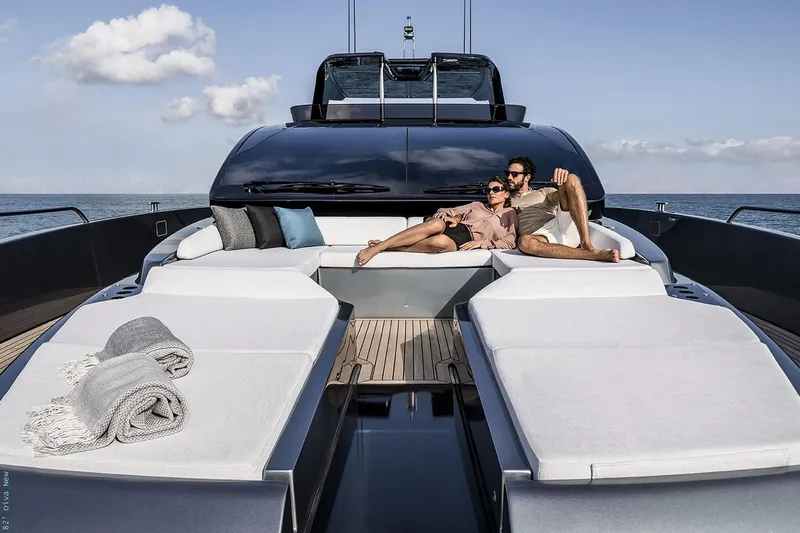  Yacht Photos Pics Manufacturer Provided Image: Couple relaxing on luxurious 2026 Riva 82' Diva yacht deck, enjoying the ocean view.