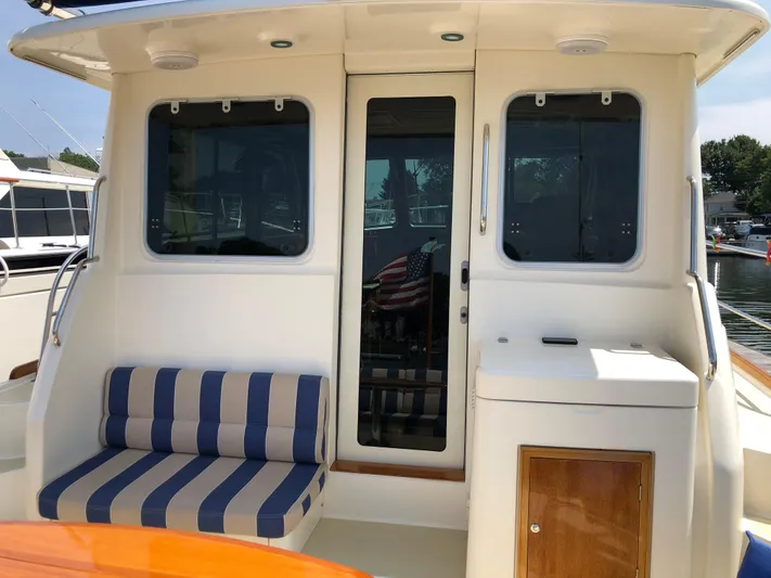  Yacht Photos Pics 2009 Sabre 40 Sedan yacht with striped seating and sleek exterior design.