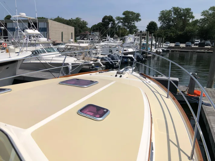  Yacht Photos Pics 2009 Sabre 40 Sedan yacht docked at marina with other boats.