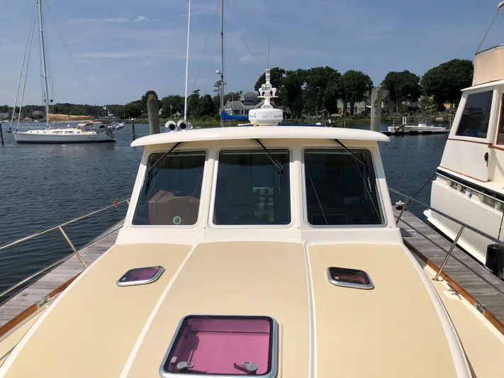  Yacht Photos Pics 2009 Sabre 40 Sedan yacht docked at a marina with scenic background.