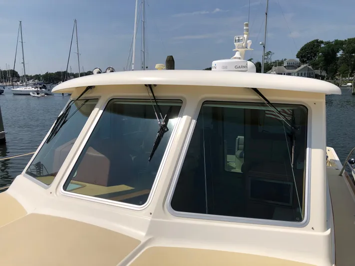  Yacht Photos Pics 2009 Sabre 40 Sedan boat with windshield and wipers, docked in a marina.