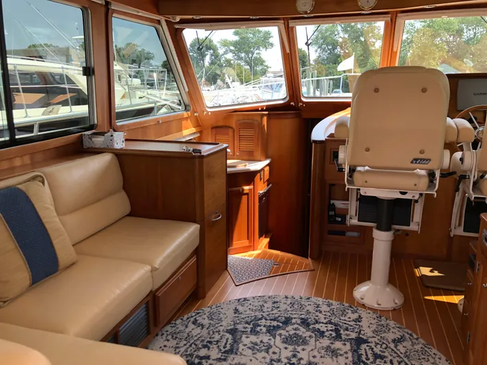  Yacht Photos Pics 2009 Sabre 40 Sedan interior with beige seating, wooden cabinetry, and helm station.
