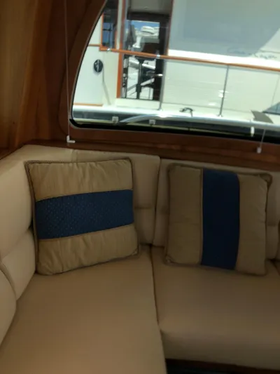  Yacht Photos Pics Interior of 2009 Sabre 40 Sedan with beige seating and blue-accented cushions.