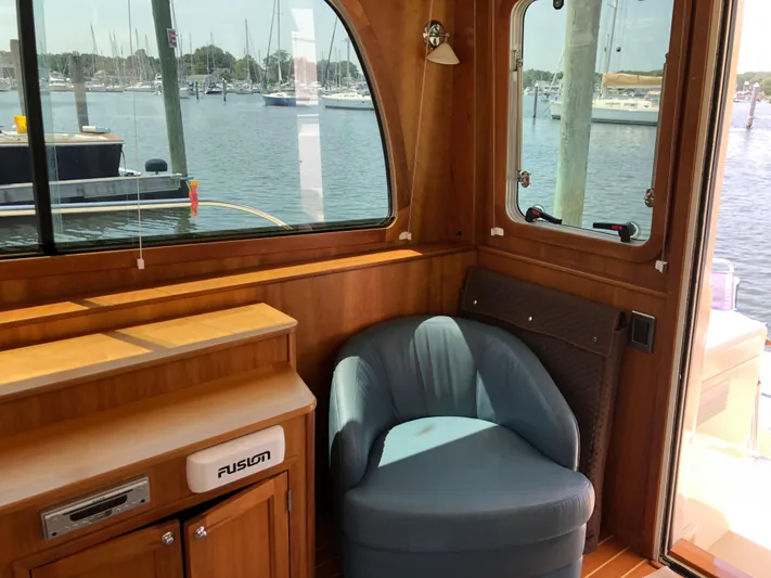  Yacht Photos Pics Interior of 2009 Sabre 40 Sedan yacht with blue chair and wooden cabinetry.