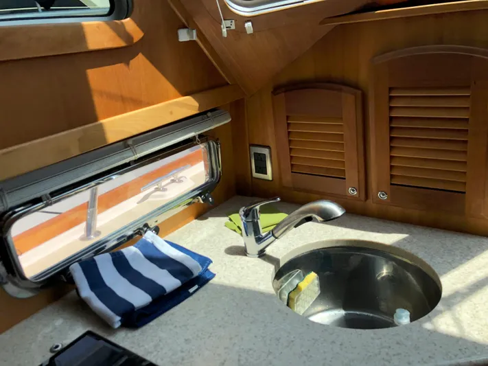  Yacht Photos Pics 2009 Sabre 40 Sedan yacht interior with sink, window, and wooden cabinets.