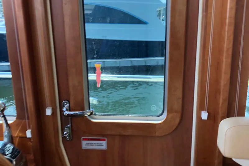  Yacht Photos Pics Wooden interior door on a 2009 Sabre 40 Sedan yacht, overlooking water.