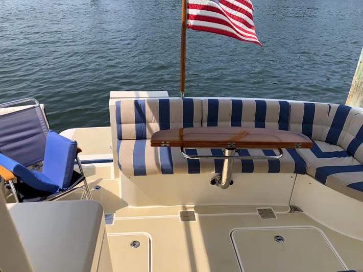  Yacht Photos Pics 2009 Sabre 40 Sedan yacht deck with striped seating and American flag.