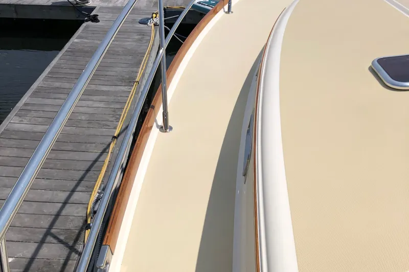  Yacht Photos Pics 2009 Sabre 40 Sedan yacht deck beside a wooden dock.