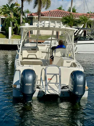  Yacht Photos Pics 2021 World Cat 280 DC-X boat with dual engines, docked in a sunny marina.