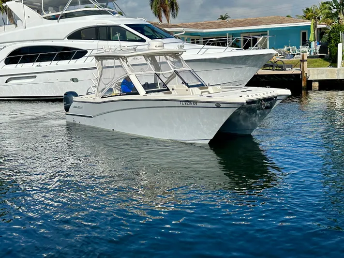  Yacht Photos Pics 2021 World Cat 280 DC-X boat docked in a marina, surrounded by water.