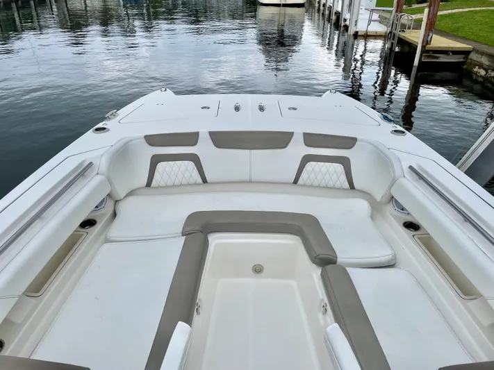  Yacht Photos Pics 2021 World Cat 280 DC-X boat with spacious seating, docked by calm waters.