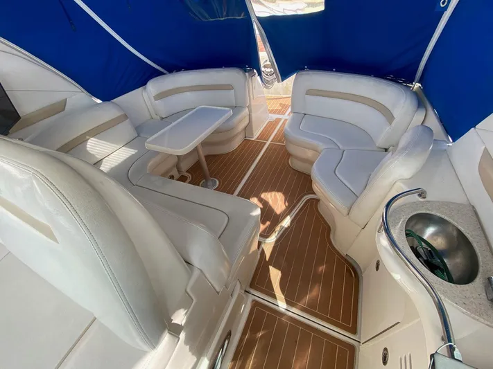 Taramina Yacht Photos Pics Luxurious interior of 2008 Sea Ray 38 Sundancer with white seating and wooden flooring.