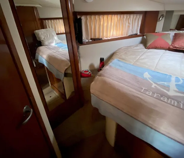 Taramina Yacht Photos Pics Interior of 2008 Sea Ray 38 Sundancer yacht bedroom with cozy bedding and mirror.