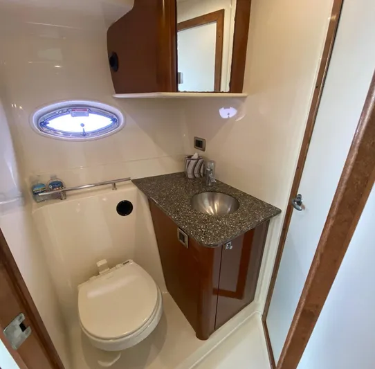 Taramina Yacht Photos Pics 2008 Sea Ray 38 Sundancer bathroom with sink, toilet, and porthole window.