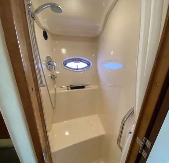 Taramina Yacht Photos Pics Shower area inside 2008 Sea Ray 38 Sundancer yacht, featuring sleek design and porthole window.