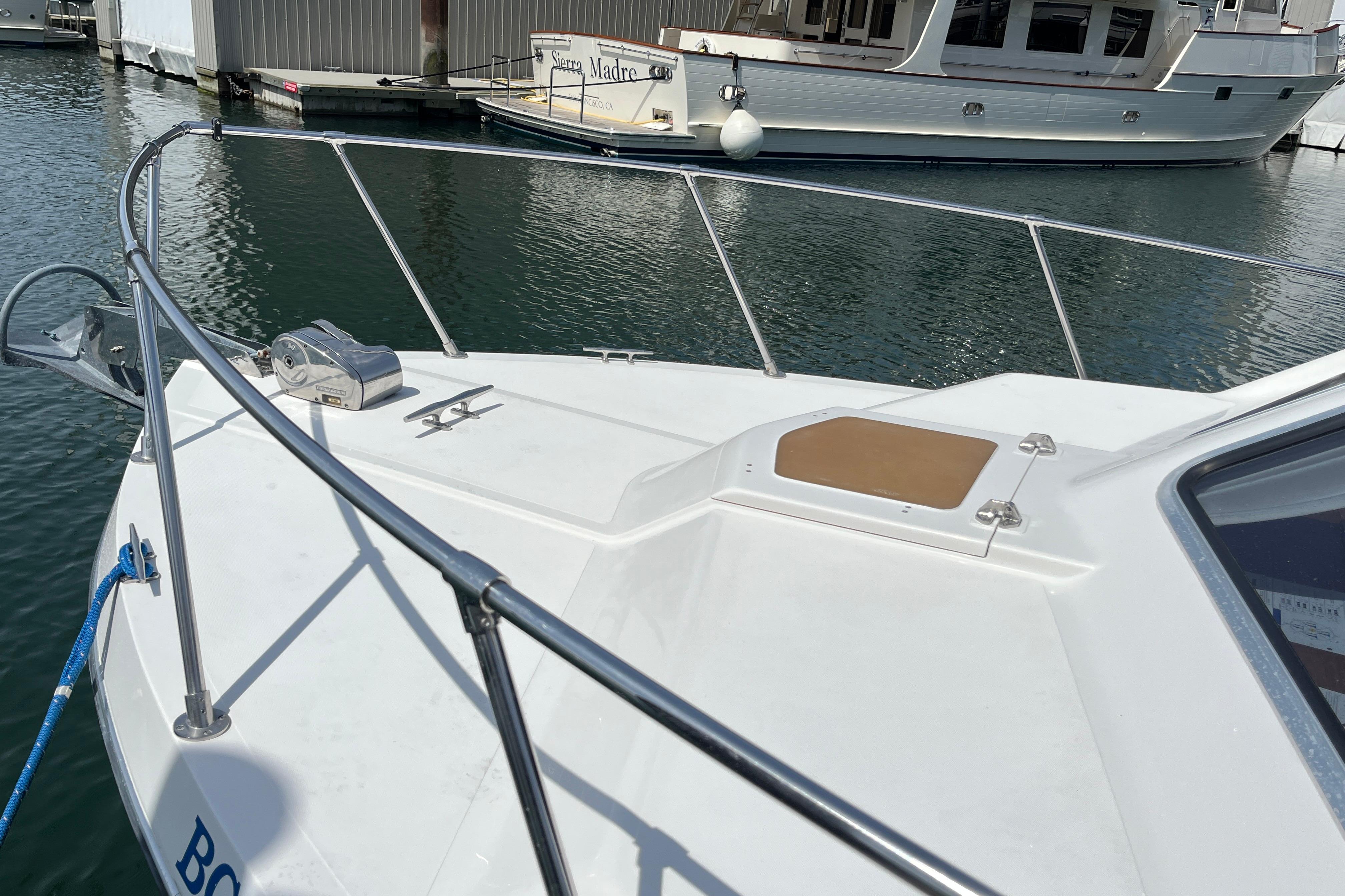 2006 Commander 26 Sedan boat docked in a marina, featuring a sleek white deck.