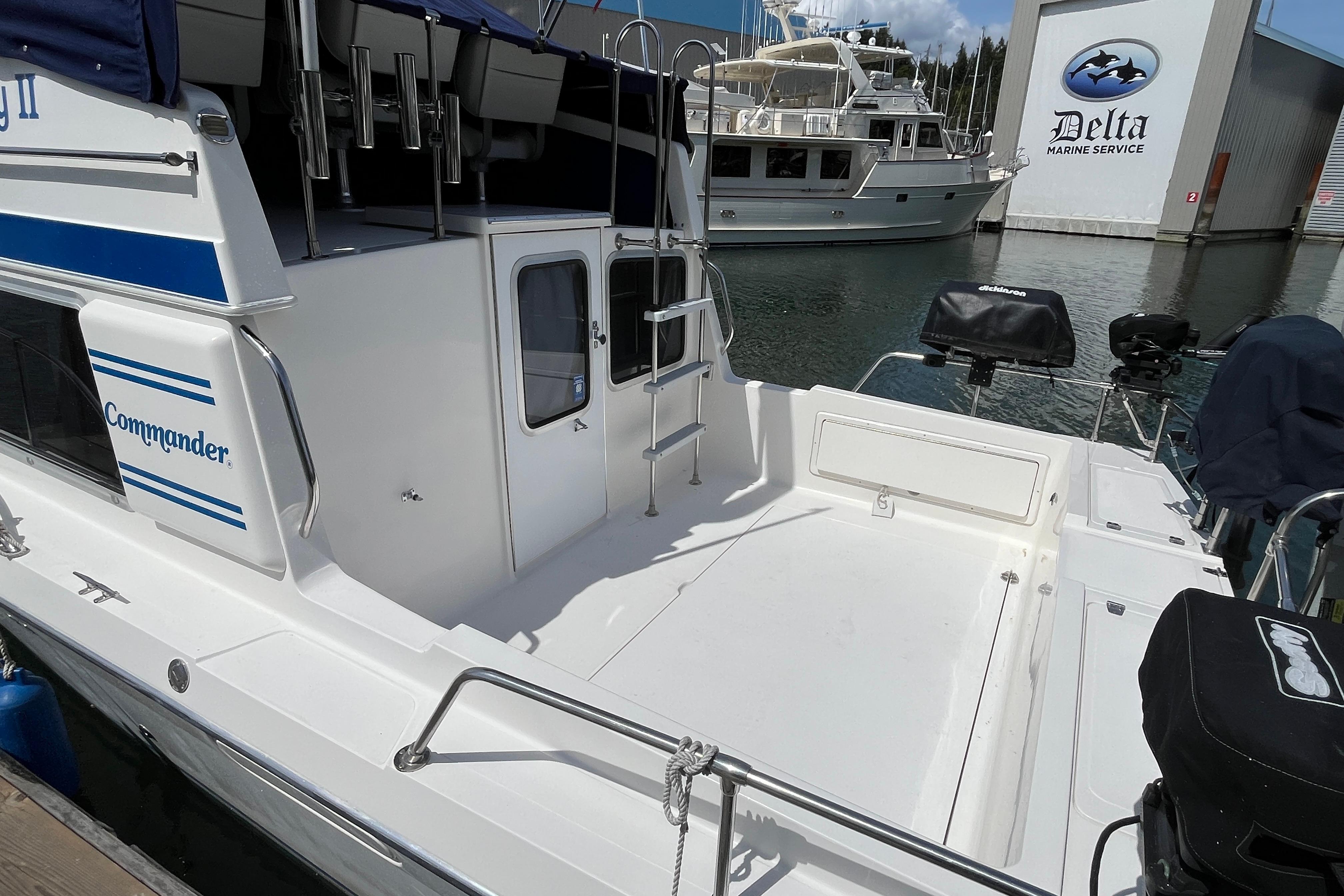 2006 Commander 26 Sedan boat docked at Delta Marine Service, featuring spacious deck area.