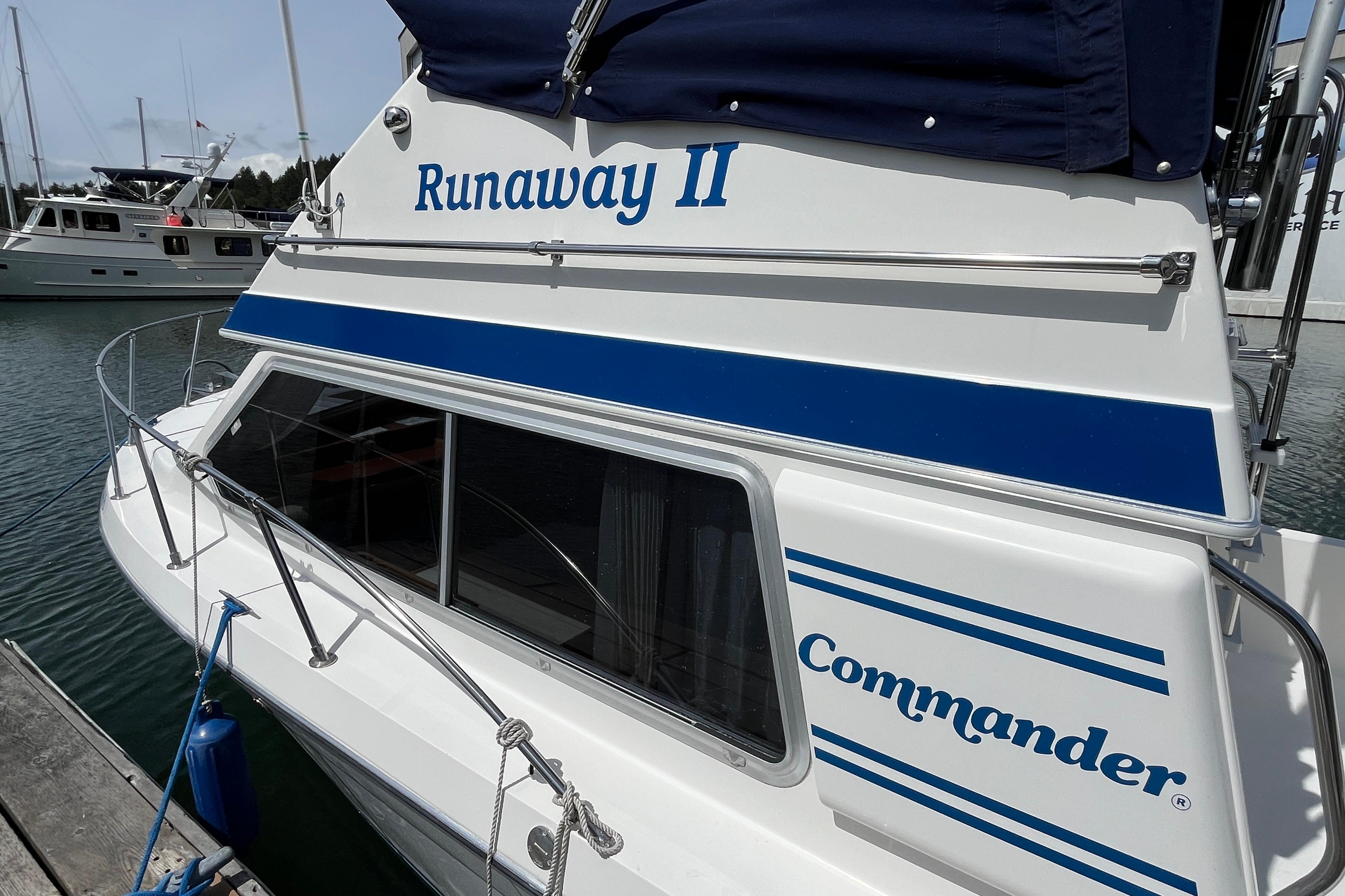 Commander 26 Sedan boat, 2006 model, named "Runaway II" docked at marina.