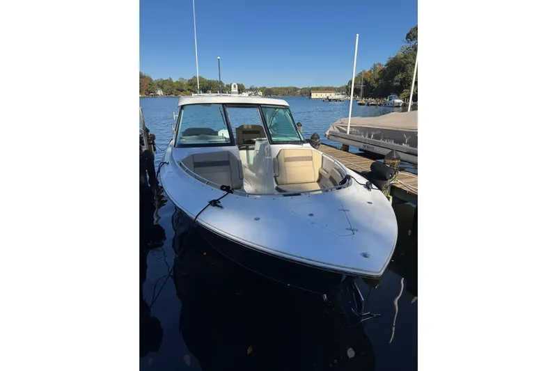 In Pursuit Yacht Photos Pics 2019 Pursuit DC 325 Dual Console boat docked on a calm lake.