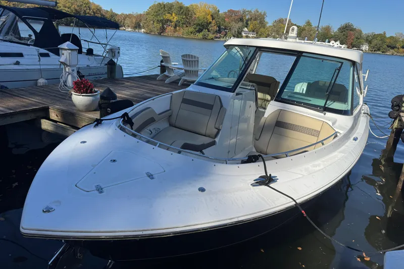 In Pursuit Yacht Photos Pics 2019 Pursuit DC 325 Dual Console boat docked on a serene lake.