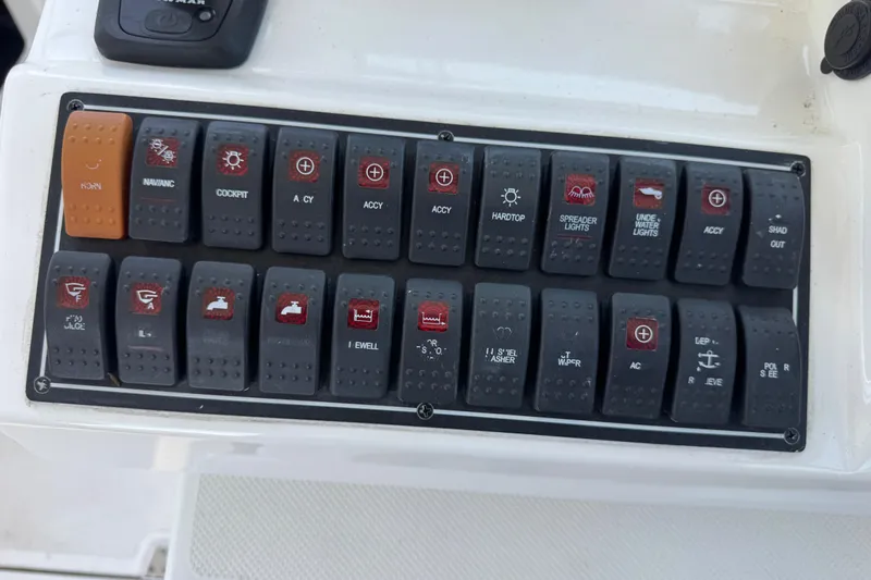 In Pursuit Yacht Photos Pics Control panel of a 2019 Pursuit DC 325 Dual Console boat with labeled switches.
