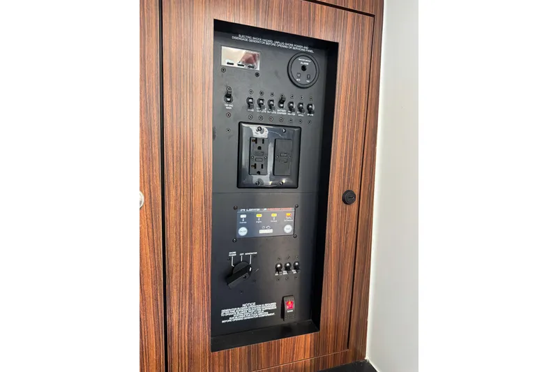 In Pursuit Yacht Photos Pics Control panel of 2019 Pursuit DC 325 Dual Console boat, featuring switches and outlets.