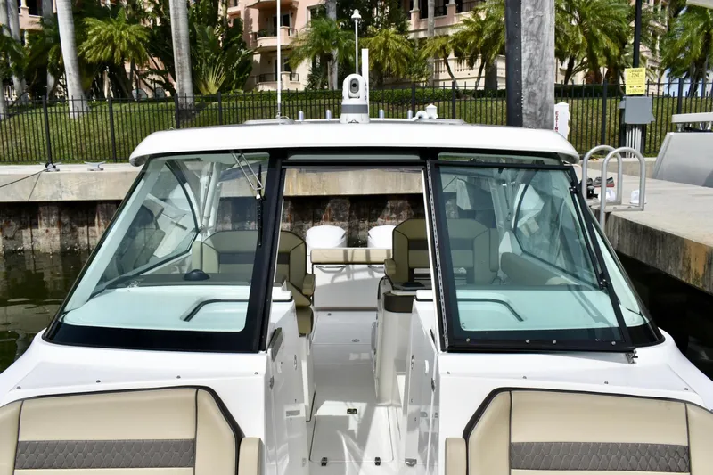 In Pursuit Yacht Photos Pics 2019 Pursuit DC 325 Dual Console boat docked, featuring spacious seating and modern design.