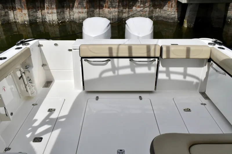 In Pursuit Yacht Photos Pics 2019 Pursuit DC 325 Dual Console boat interior with seating and storage.