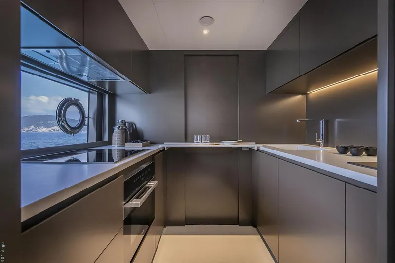 Riva Argo 90 Yacht Photos Pics Manufacturer Provided Image: Modern kitchen interior on 2026 Riva 90' Argo yacht, featuring sleek cabinetry and ocean view.