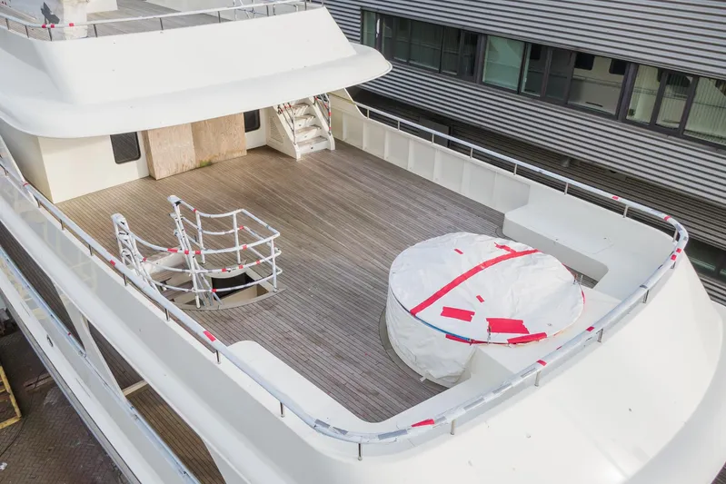 Valeria Yacht Photos Pics 1975 Feadship Motoryacht deck with wooden flooring and covered equipment.