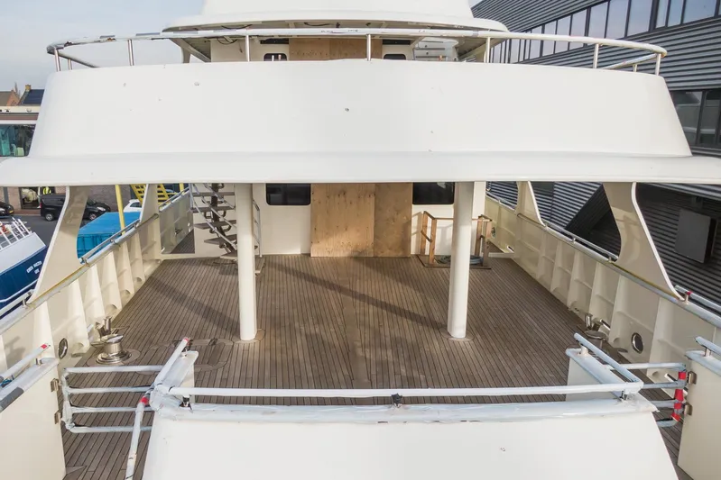 Valeria Yacht Photos Pics 1975 Feadship Motoryacht with spacious wooden deck and modern design elements.