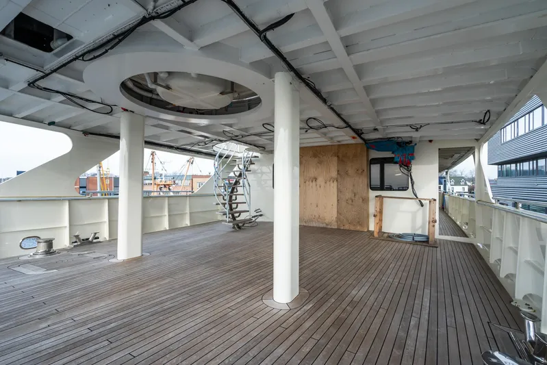 Valeria Yacht Photos Pics 1975 Feadship Motoryacht deck with wooden flooring and spiral staircase.