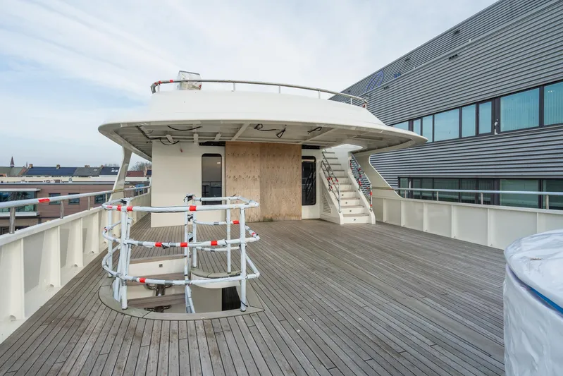 Valeria Yacht Photos Pics 1975 Feadship Motoryacht deck with wooden flooring and modern design elements.