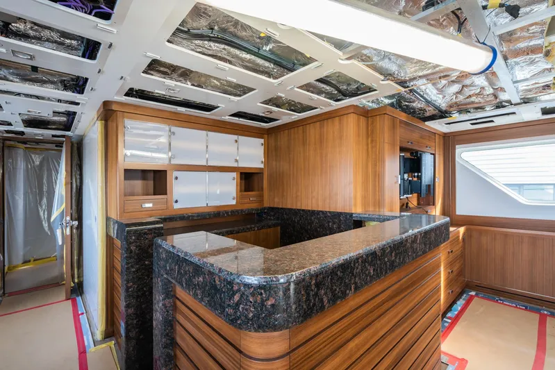 Valeria Yacht Photos Pics Luxurious 1975 Feadship motoryacht interior with wood paneling and granite countertops.
