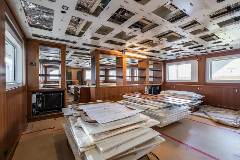 Valeria Yacht Photos Pics 1975 Feadship Motoryacht interior under renovation, featuring wooden paneling and ceiling work.