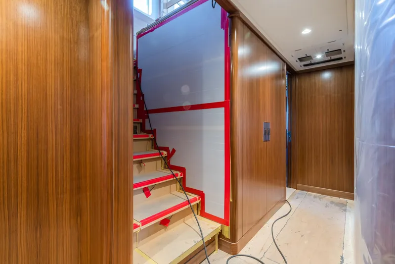 Valeria Yacht Photos Pics Interior of 1975 Feadship Motoryacht with wooden paneling and staircase under renovation.