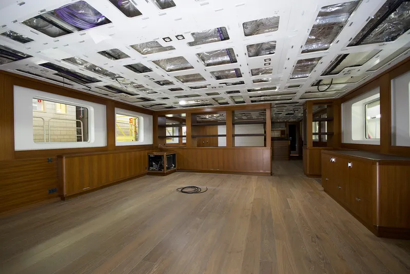 Valeria Yacht Photos Pics Spacious interior of a 1975 Feadship motoryacht with wooden flooring and modern design elements.