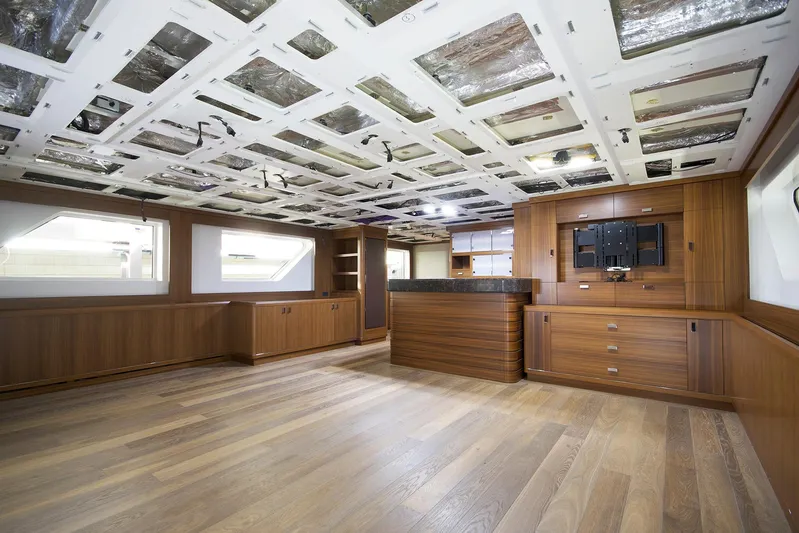 Valeria Yacht Photos Pics Spacious interior of 1975 Feadship Motoryacht with wooden flooring and modern design elements.