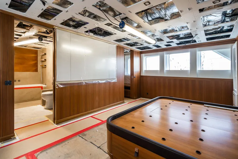 Valeria Yacht Photos Pics 1975 Feadship motoryacht interior under renovation, featuring wood paneling and modern fixtures.